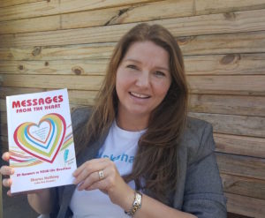 Sharon Halliday proudly shows off her debut book Messages from the Heart