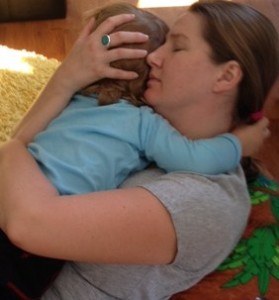 Blogger Sharon Halliday hugs her child to comfort from homesickness